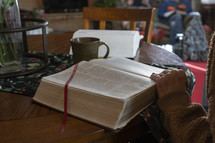 A woman looking up a Bible verse at a home study