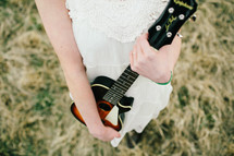 a woman holding a guitar 