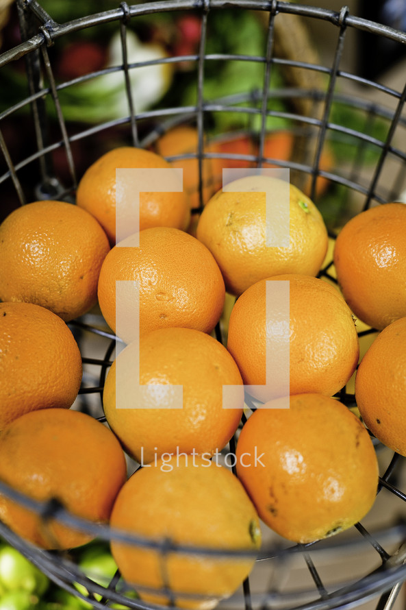 oranges in a metal basket