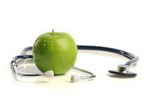 stethoscope and a green apple 