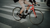 a man on a bike crossing over a crosswalk in Paris 