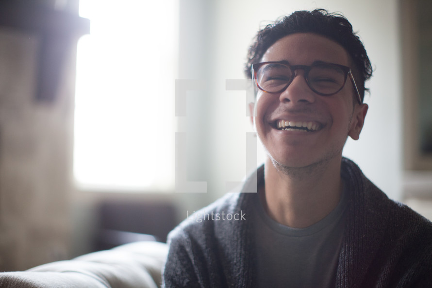 a joyful man in reading glasses 