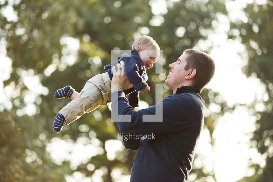A Dad holding his Son in the air