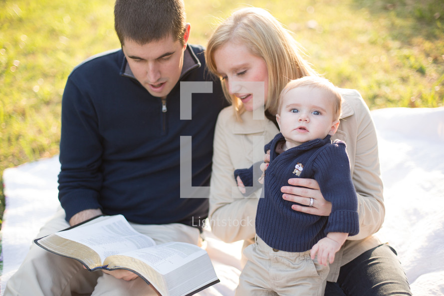 family sitting together reading the Bible