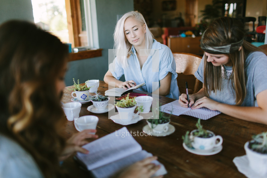 young women reading Bibles at a Bible study 