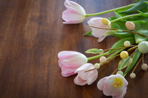tulips and Easter sprig on wood table 