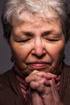 headshot of a woman in prayer 