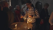 Man Lighting Incense at the church of the holy sepulchre in Jerusalem Israel Pilgrim Penance