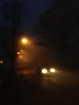 out of focus image of a cars headlights 