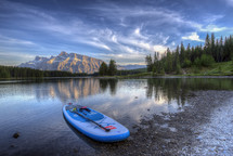 paddle board on a lake shore 