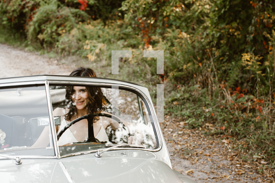 bride driving a vintage car 