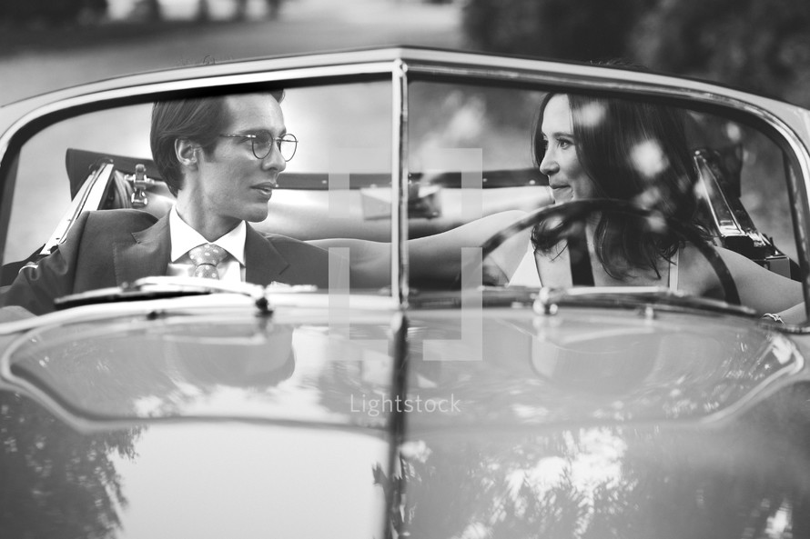 bride and groom in a vintage car