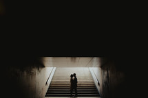 a couple standing in a subway 