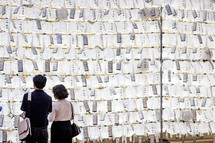 A Korean couple reading prayer lanterns