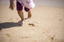 Child running on a sandy beach in Busan, Korea