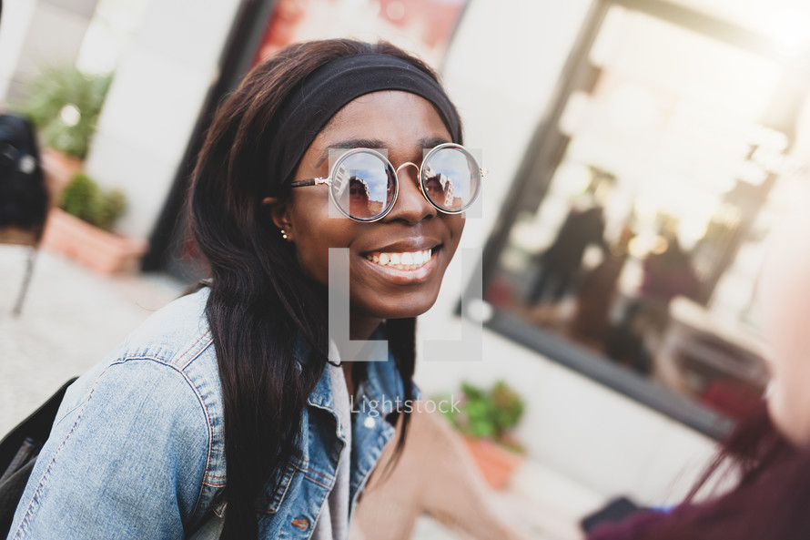 Portrait of a young smiling girl of African ethnicity in outdoor.