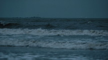 Beacon illuminating the night stormy sea.
