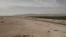 drone Road Highway running through barren desert driving road trip aerial 