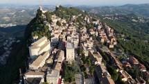 Aerial drone shot flying over the length of the historic center of San Marino.