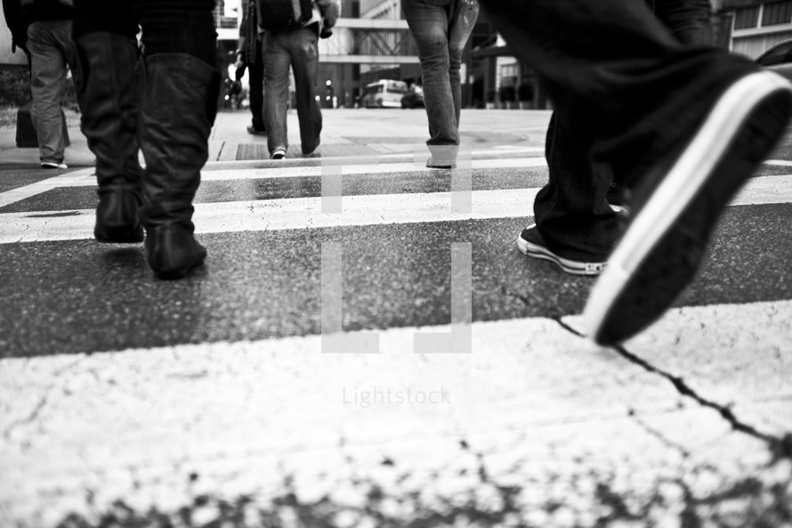feet on a city crosswalk