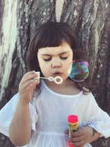 a child blowing bubbles 