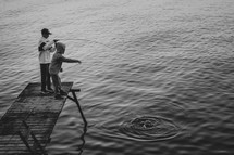 boys fishing on a pier 