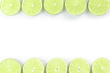 Lime slices bordering a white background
