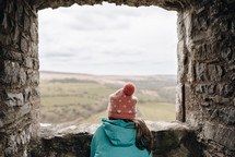 child looking out a castle window 