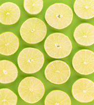 Sliced lemons against a green background