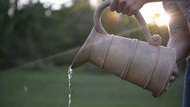 pouring water from a pitcher 