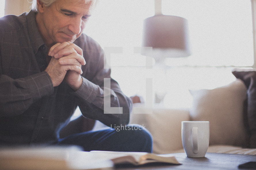 praying praying over a Bible 