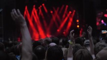 A slow motion of a cheering crowd at a concert show