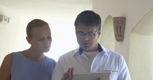 Doctor with tablet talking to female patient