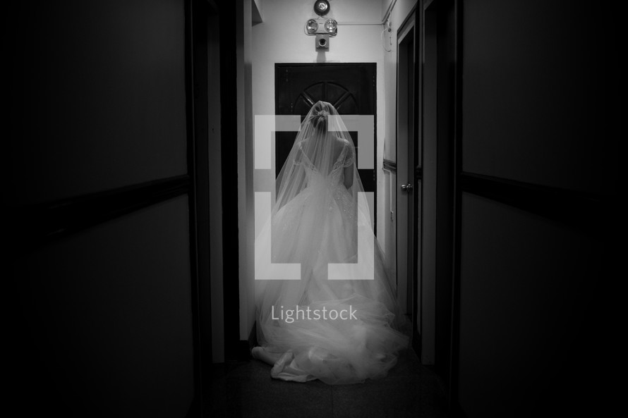 a bride walking down a hallway 