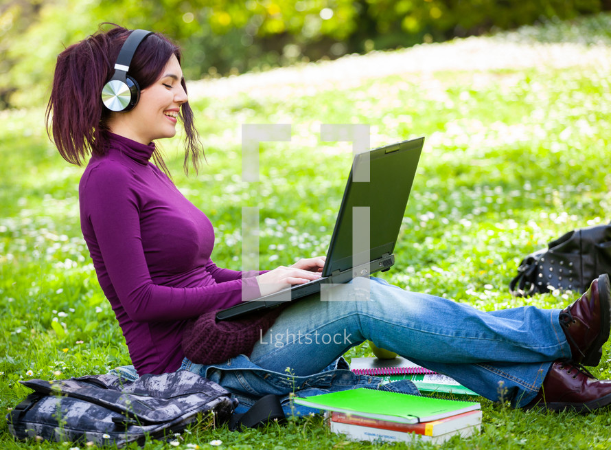 young woman listening music with headphones.