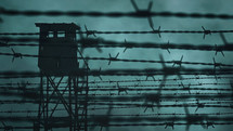 Prison barbed wire and a watchtower
