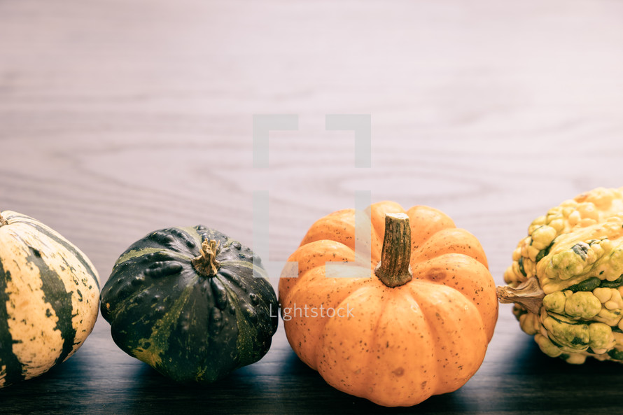 Gourds on gray wood.