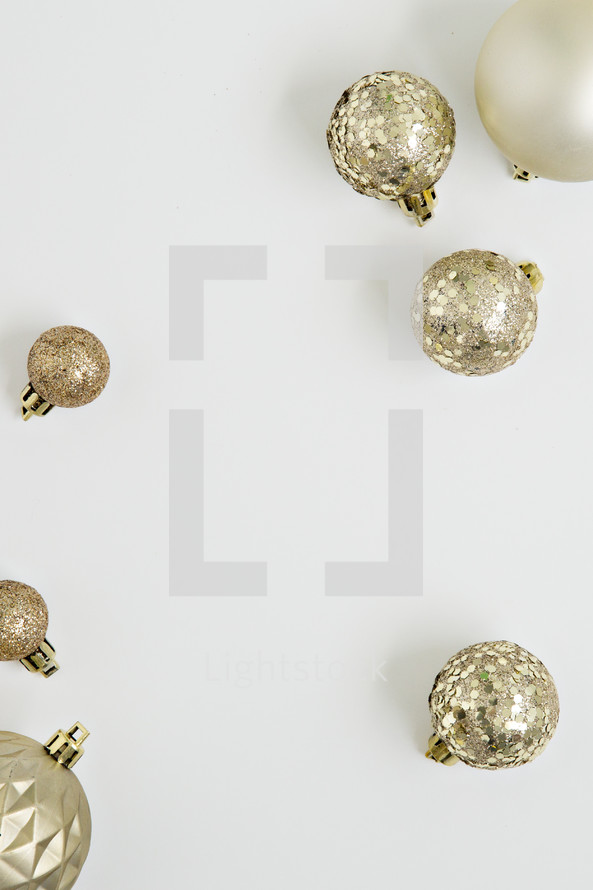 gold Christmas ornaments on white 