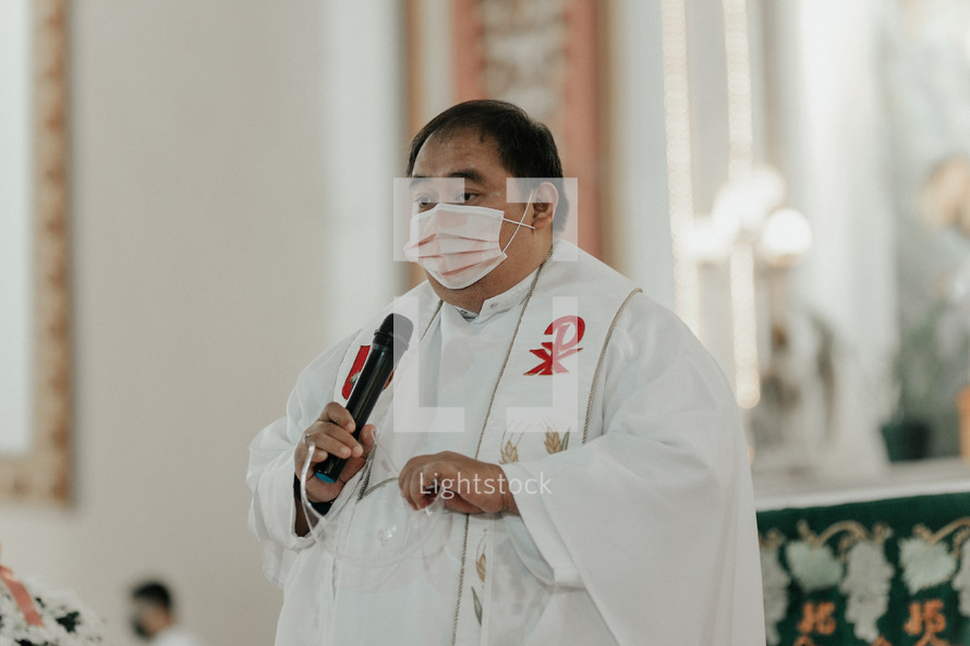 priest wearing a face mask 