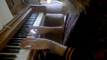 a woman playing a piano and writing music 