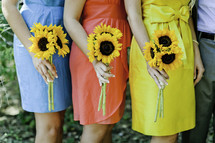 Women holding sunflowers