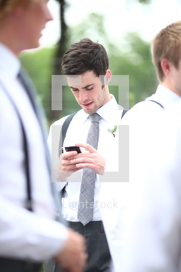 groomsmen checking his phone