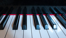 Keys reflecting on piano close-up horizontal