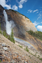 waterfall with rainbow - mountain cliff