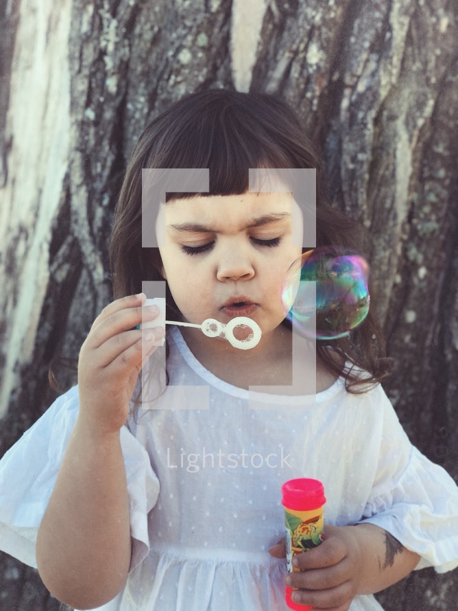 a child blowing bubbles 