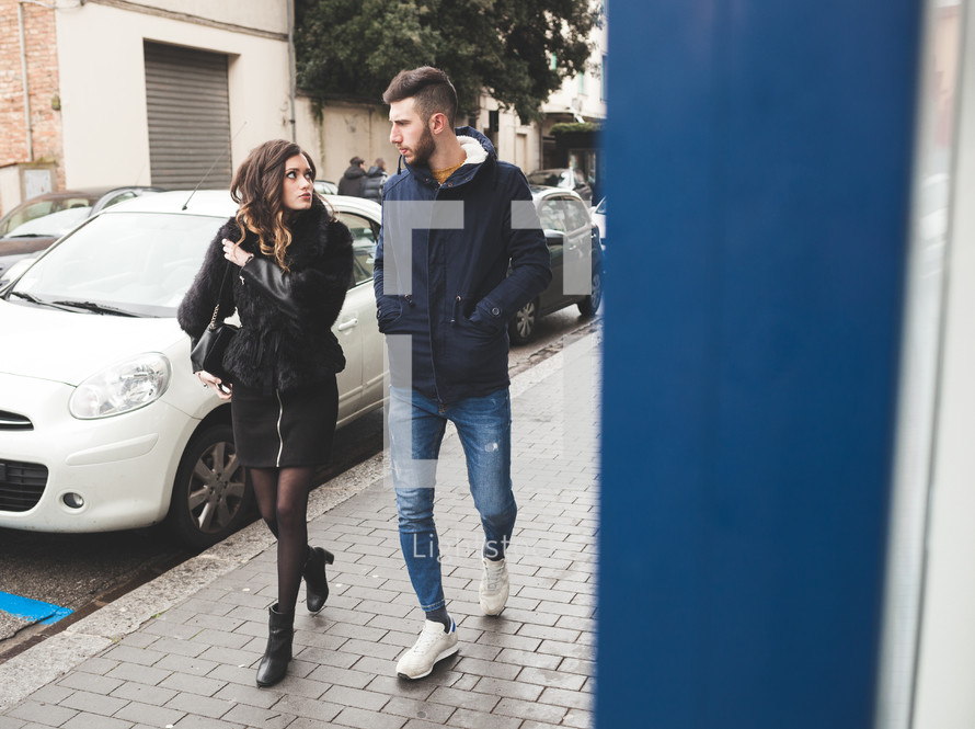 Young couple walking in a winter day. Urban fashion and relationship concept