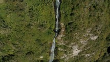 Aerial drone shot of Water Cascading Down Lush Mountains, Manto de la novia Waterfall In Ecuador.