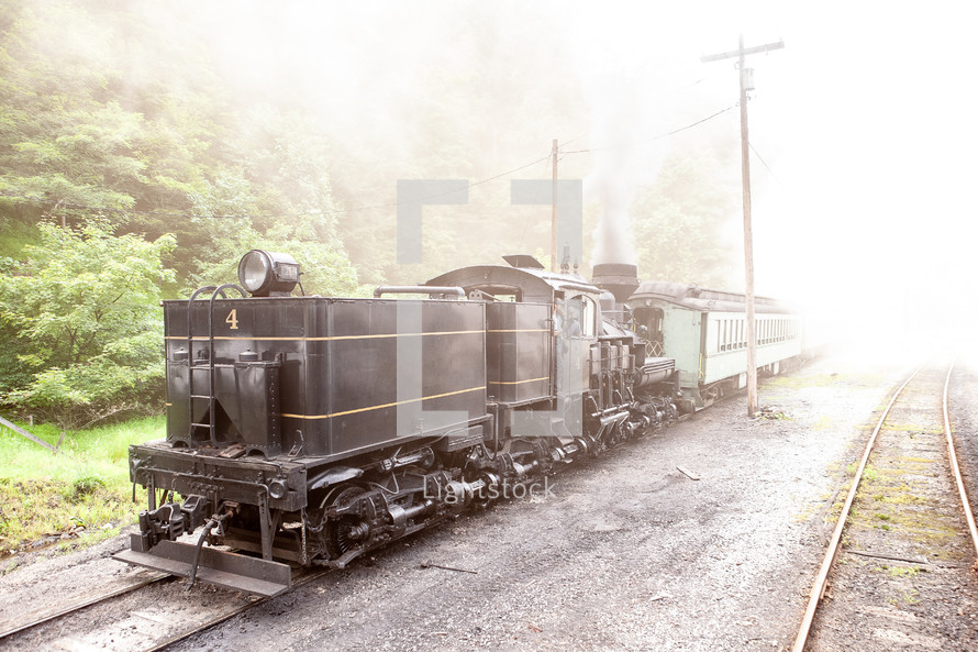 Old black train locomotive on scenic railway