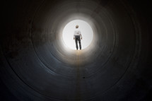 Man in the light at the end of a dark tunnel