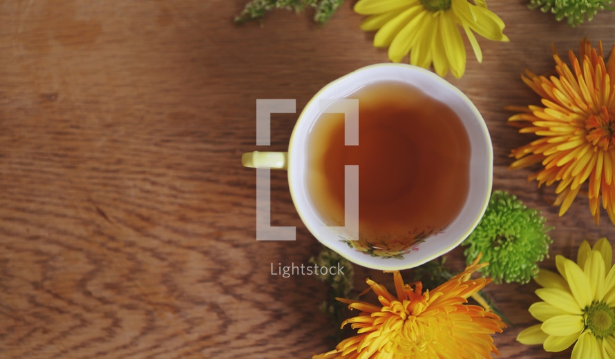 a cup of tea with bright flowers and copyspace